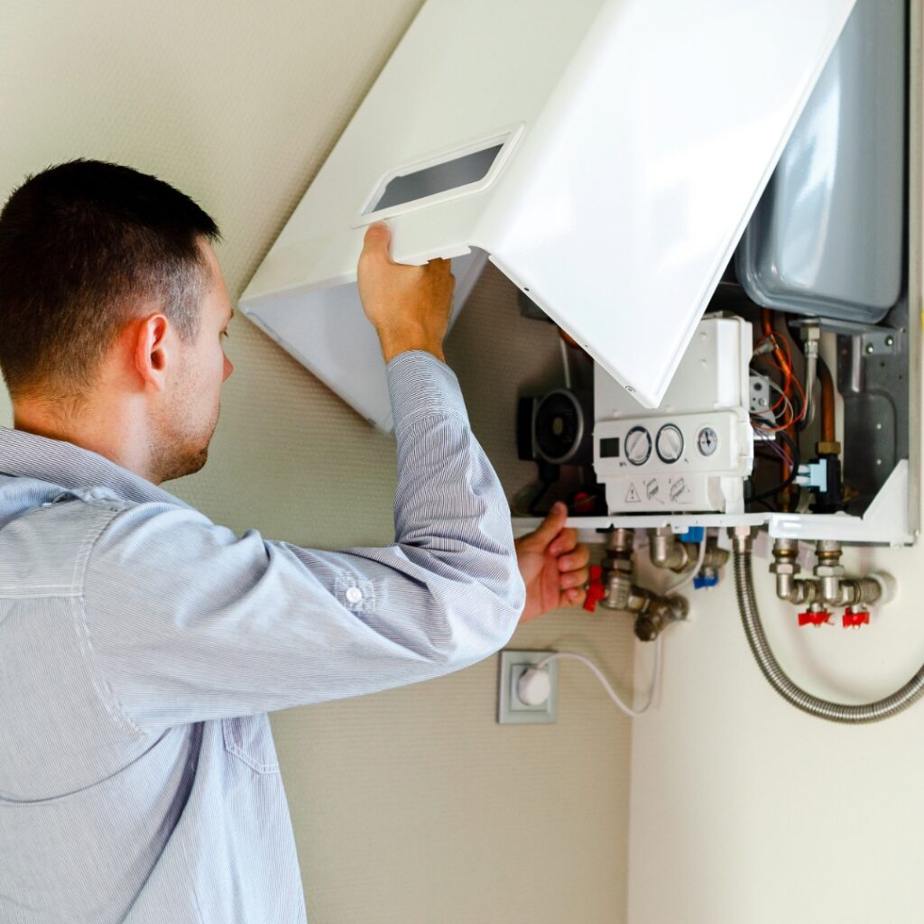 Boiler Installation - Fateh Plumbing & Electric setting up a new high-efficiency boiler system for residential heating.